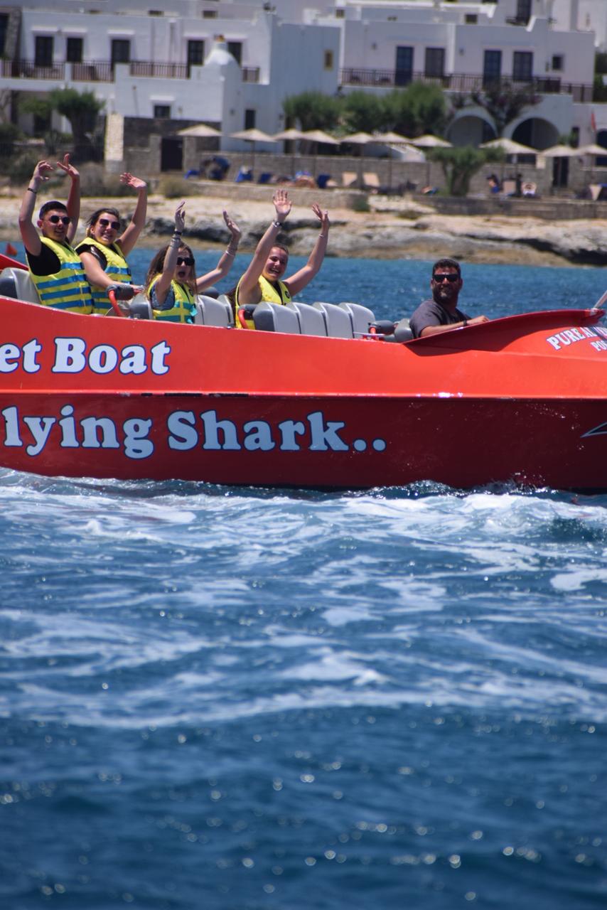 Jet boat cruising through waves under blue sky in Crete